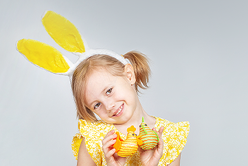 Child holding Easter Eggs like chicks