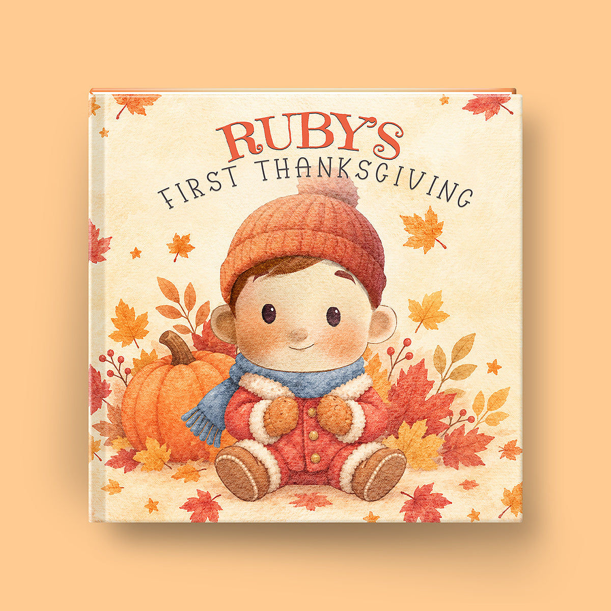 A square hardcover book cover featuring an illustrated child in a knit orange hat and blue scarf sitting beside an orange pumpkin among autumn leaves. The title reads “RUBY'S FIRST THANKSGIVING” in orange and dark lettering on a warm cream background, shown against a peach backdrop.
